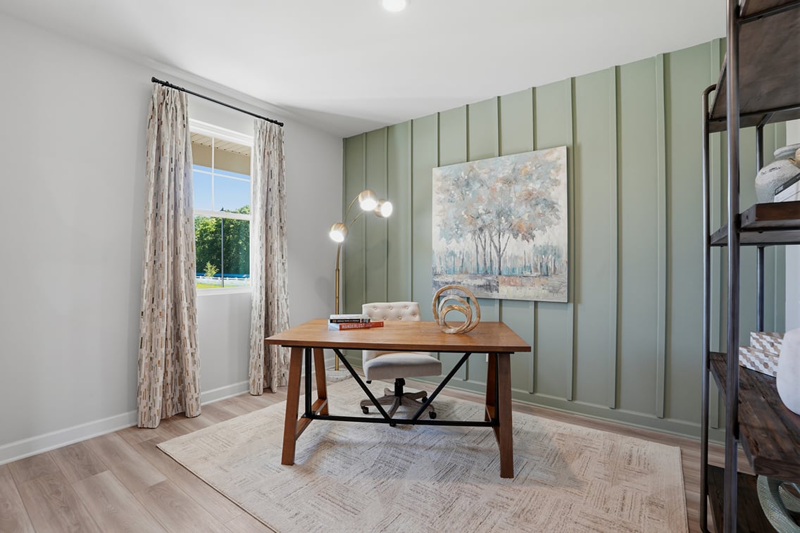 A room with a table and a window with a map on it.