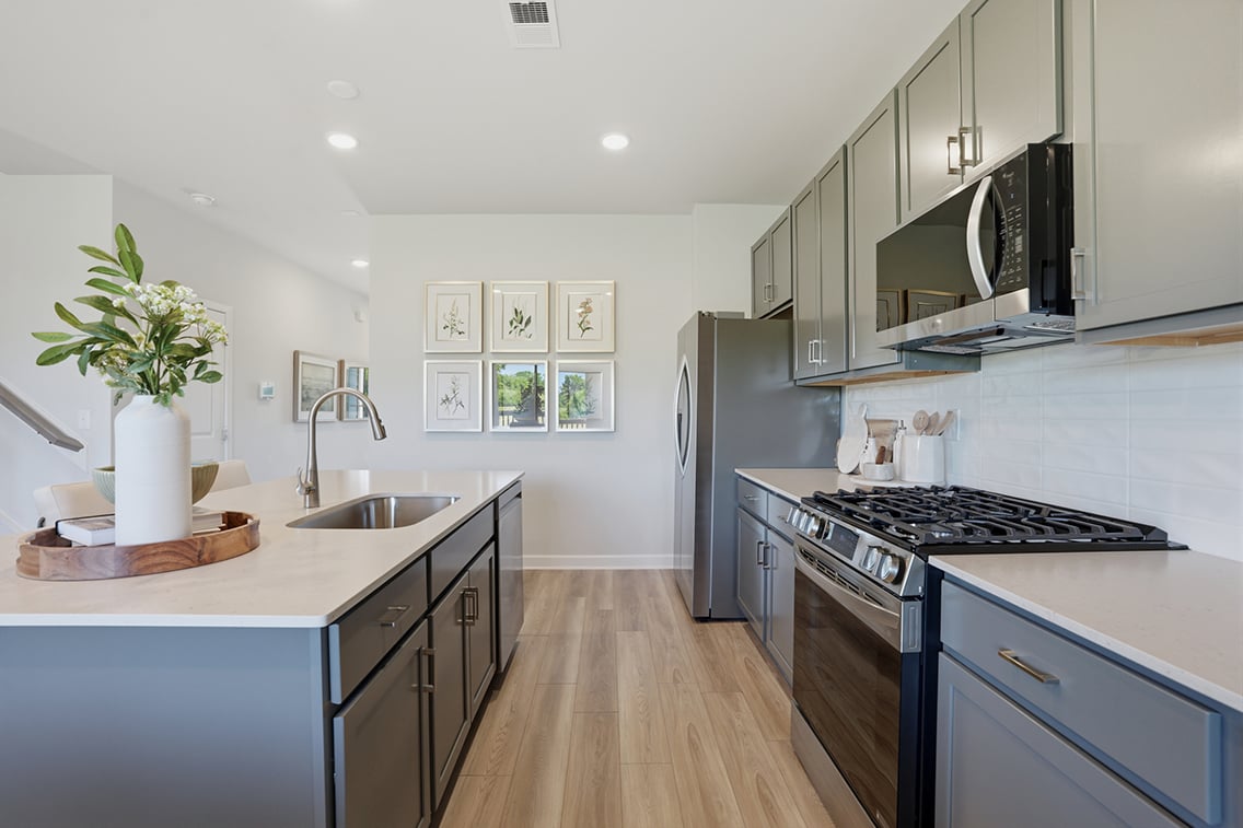 A kitchen with a stove and a sink.