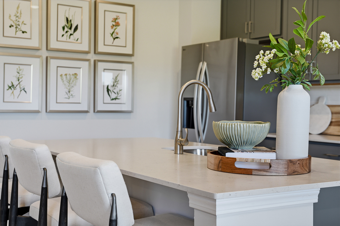 A kitchen with a table and chairs.