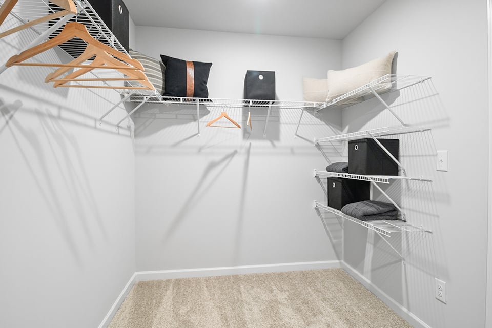 A room with a bed and a chair.