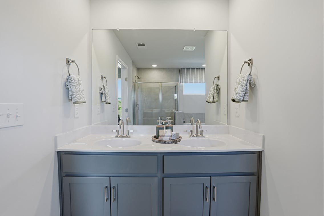 A bathroom with a large mirror.