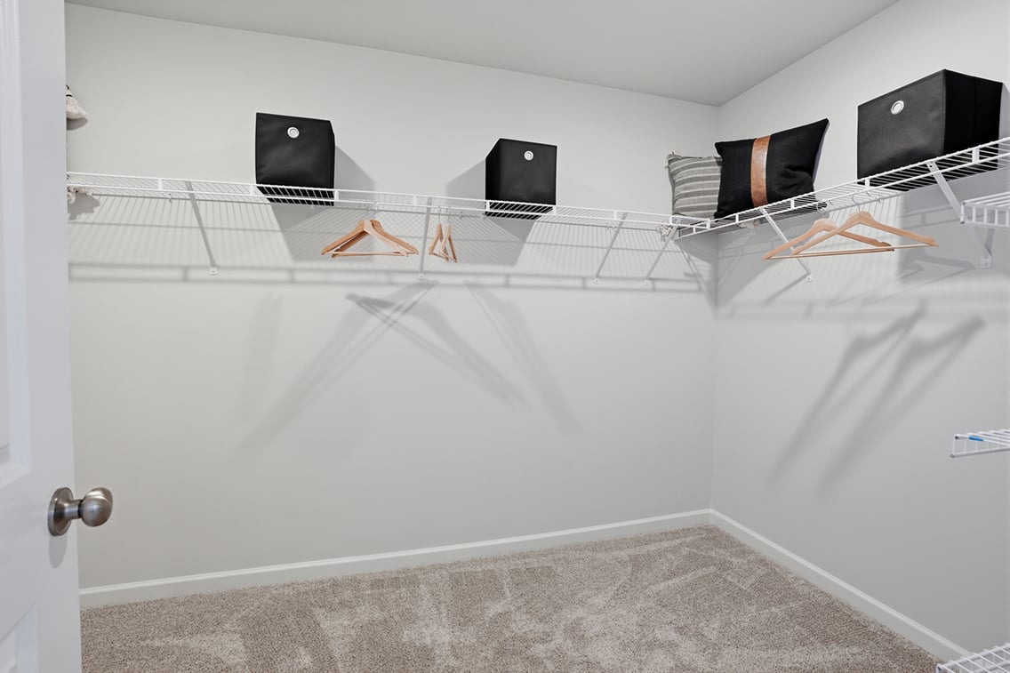 A white room with a bed and a tv.
