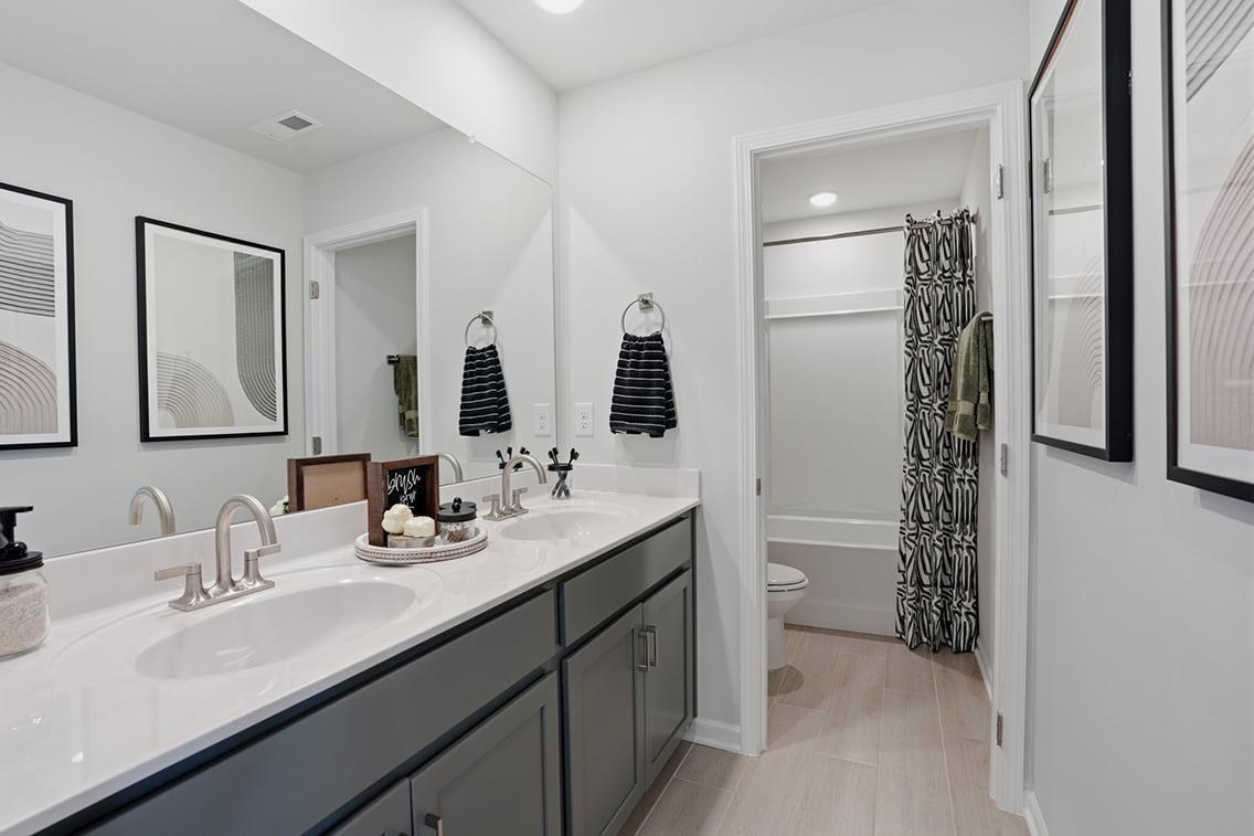 A bathroom with a sink and a shower.