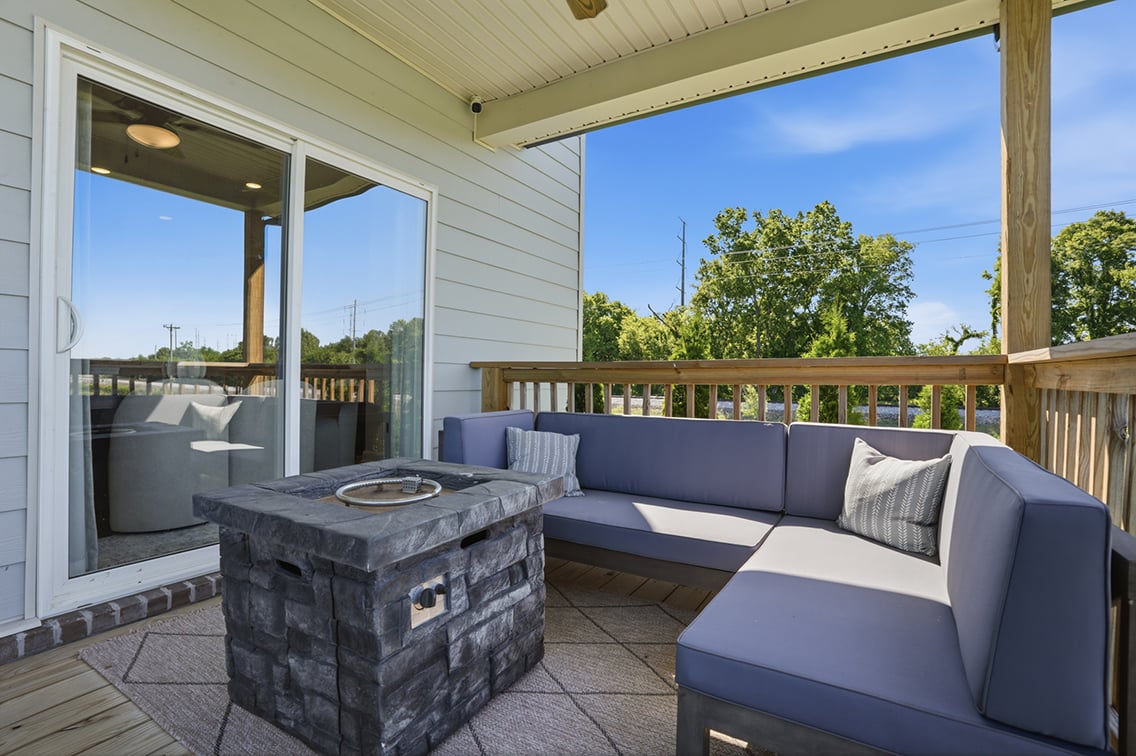 A couch and a table outside a house.