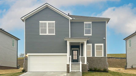 A white house with a garage.