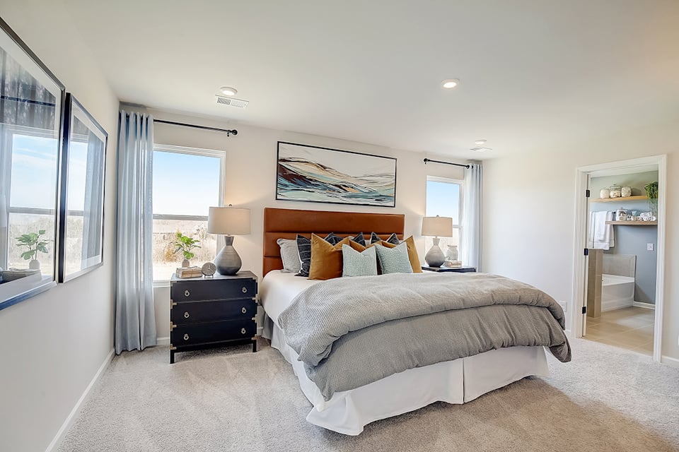 A bedroom with a bed and a desk.