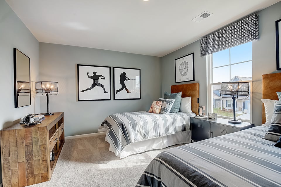A bedroom with a bed and a window.