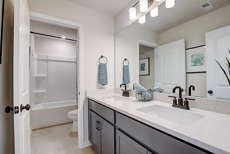 A bathroom with a sink and a shower.