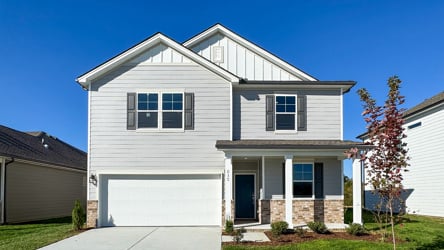 A white house with a garage.