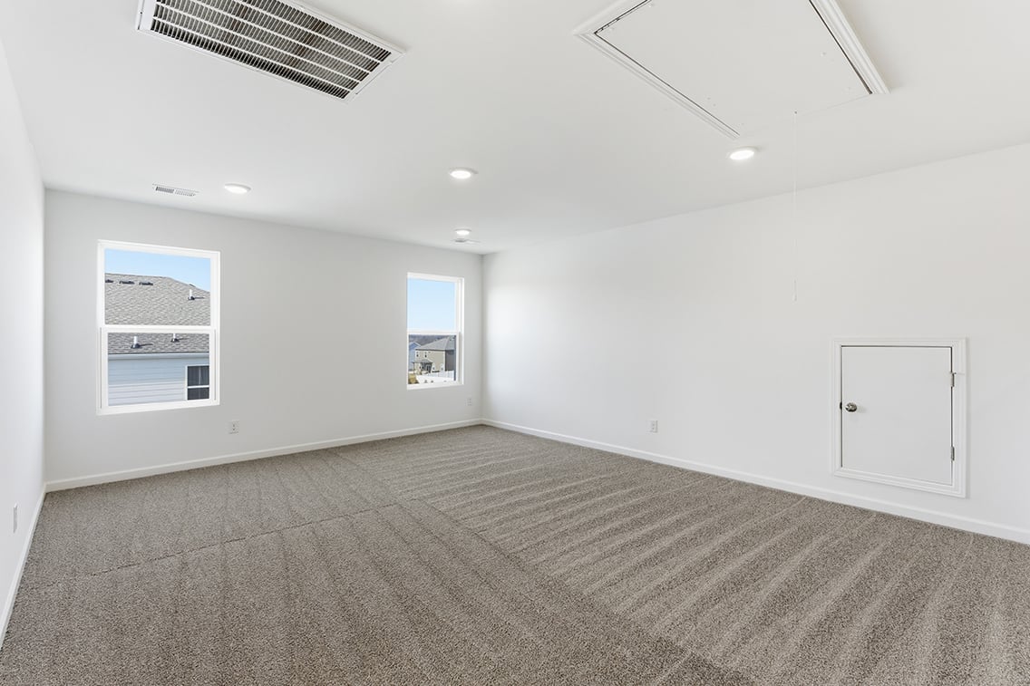 A room with white walls and a carpeted floor.