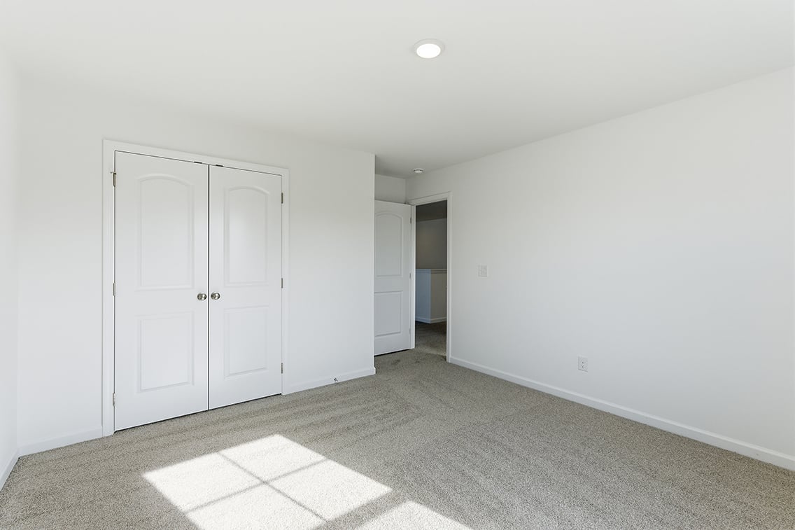 A hallway with white doors.