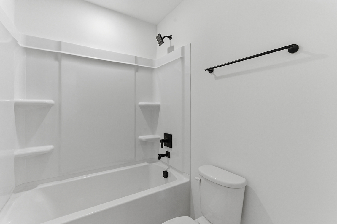A bathroom with a bathtub toilet and sink.