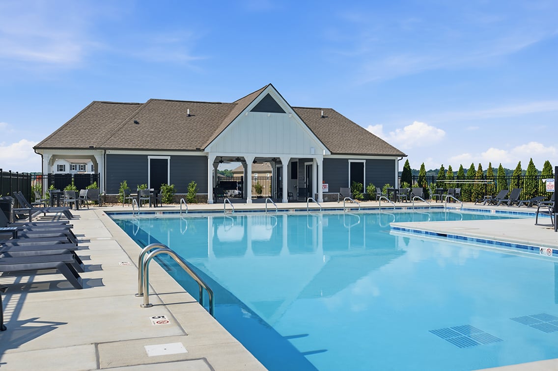 A swimming pool outside a house.