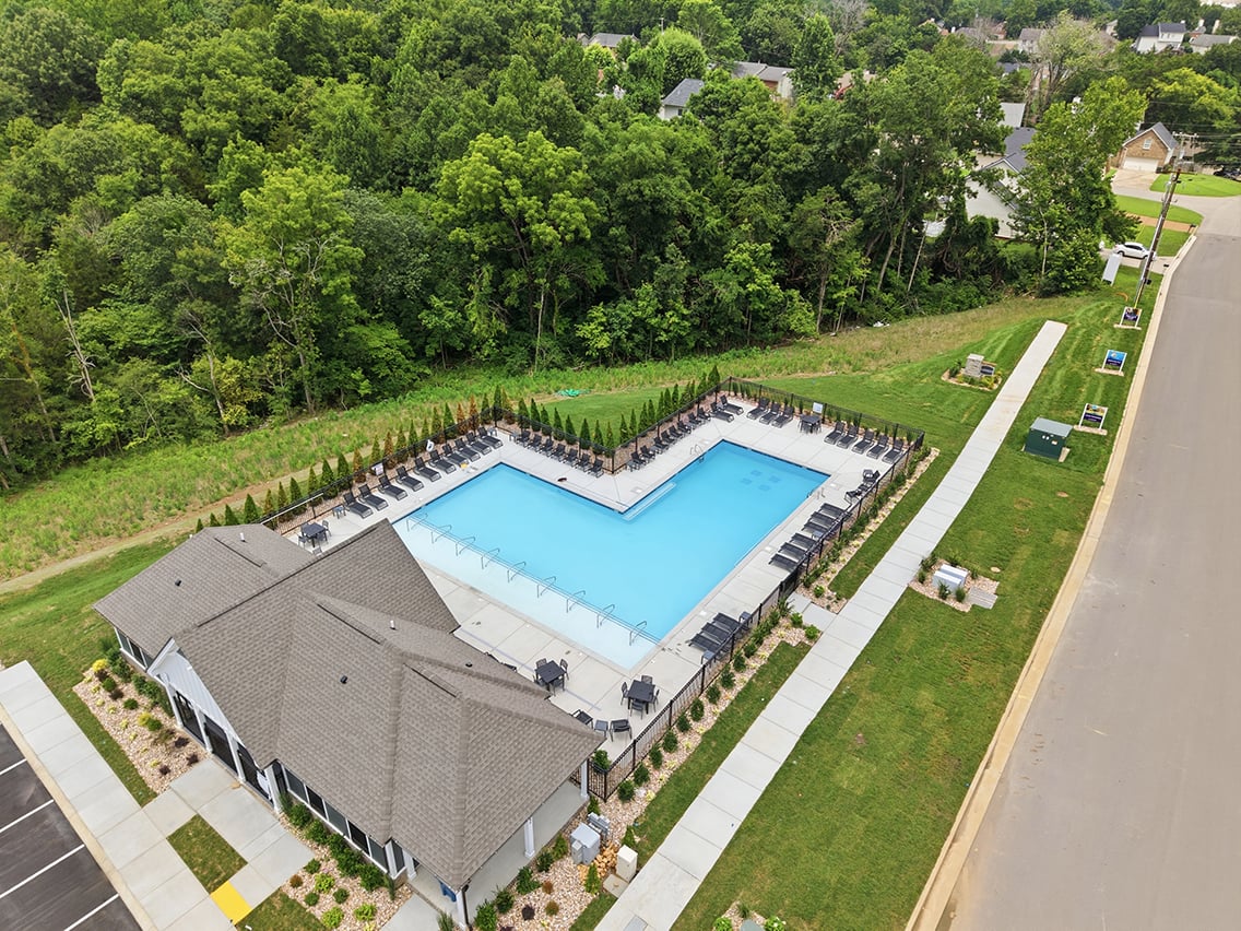 A pool surrounded by trees.
