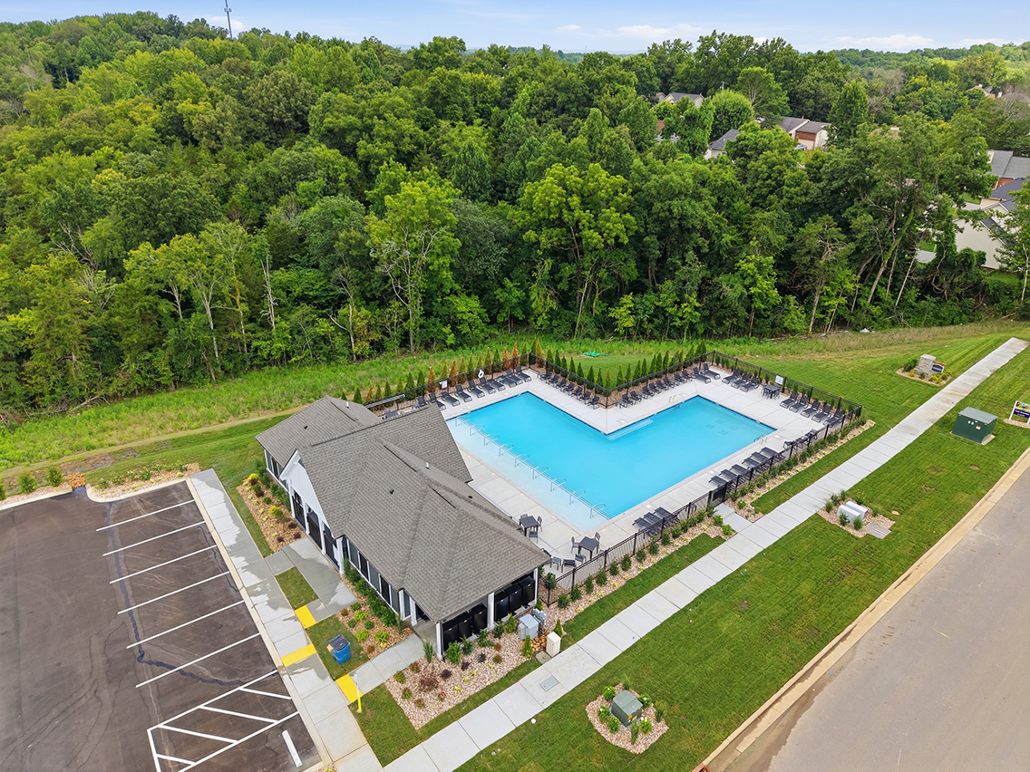 A building with a pool in the middle of a park.