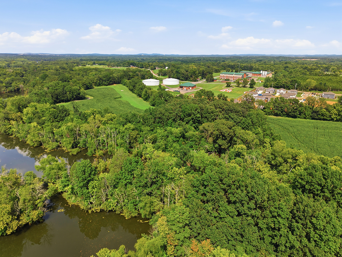 A river with trees and buildings.