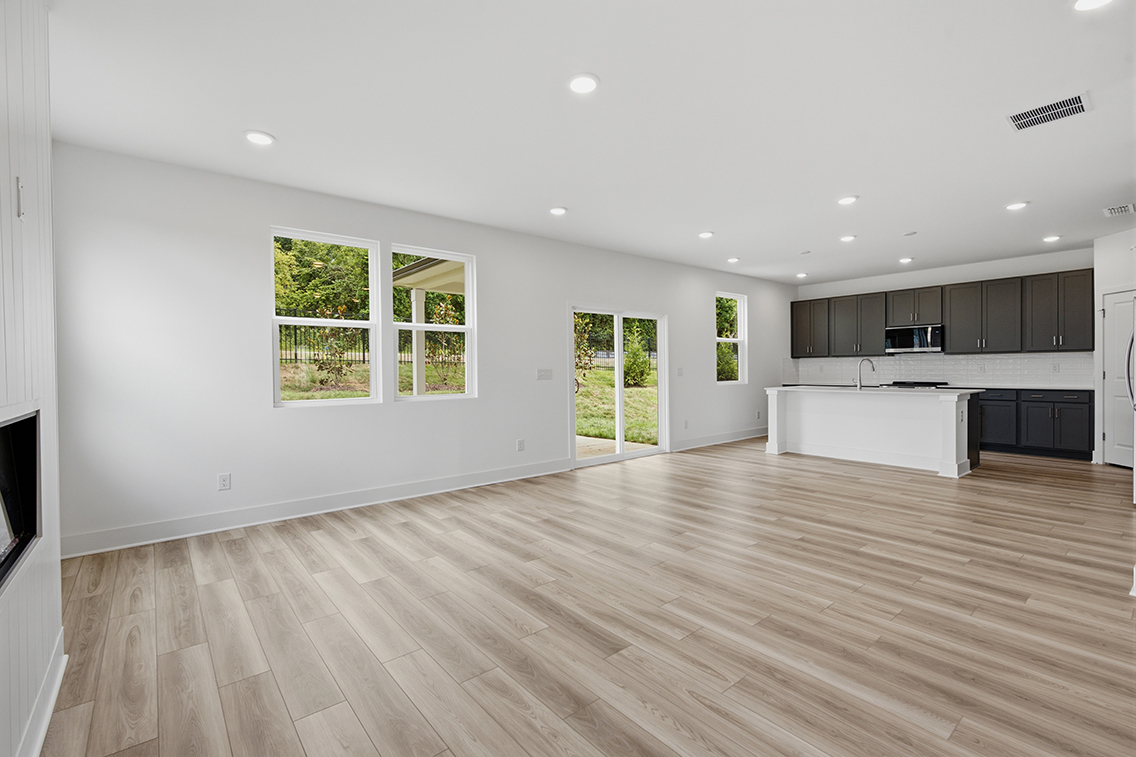 A large kitchen with a wood floor.