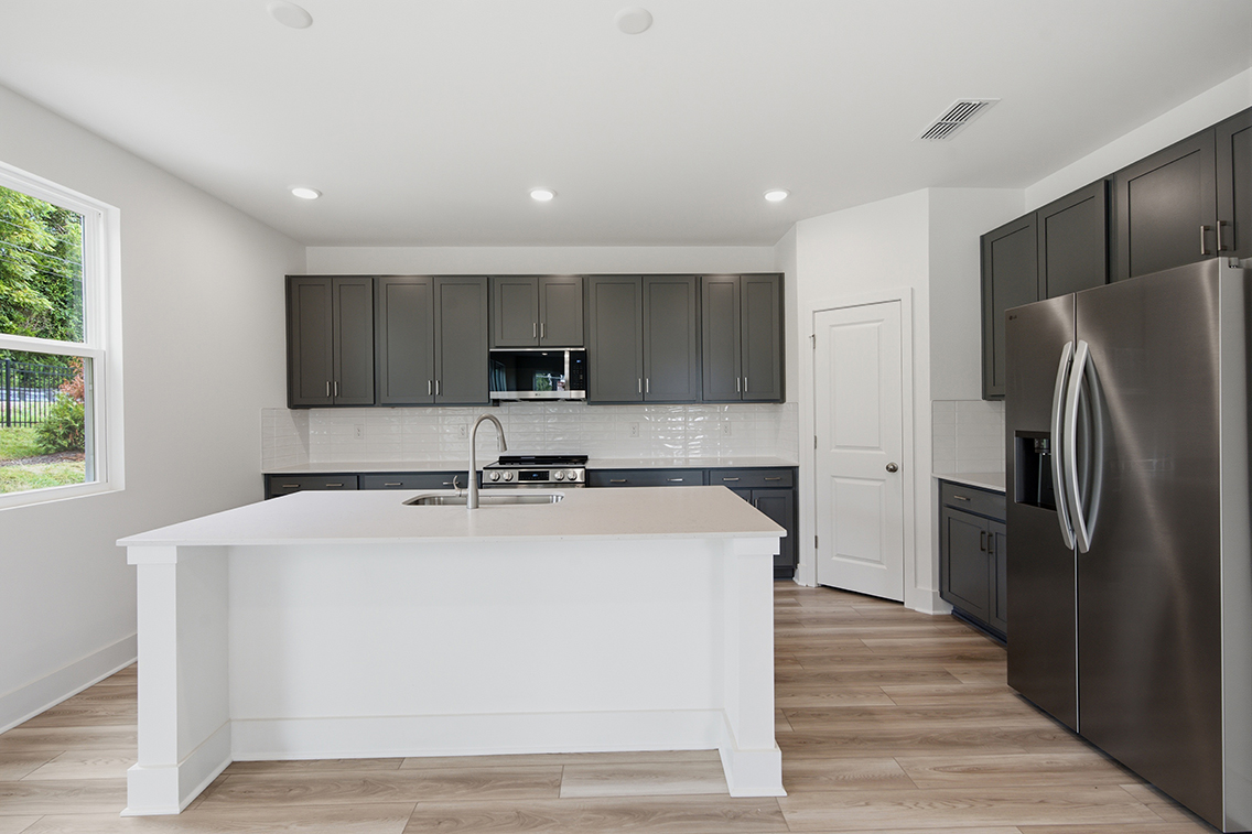 A kitchen with black cabinets.