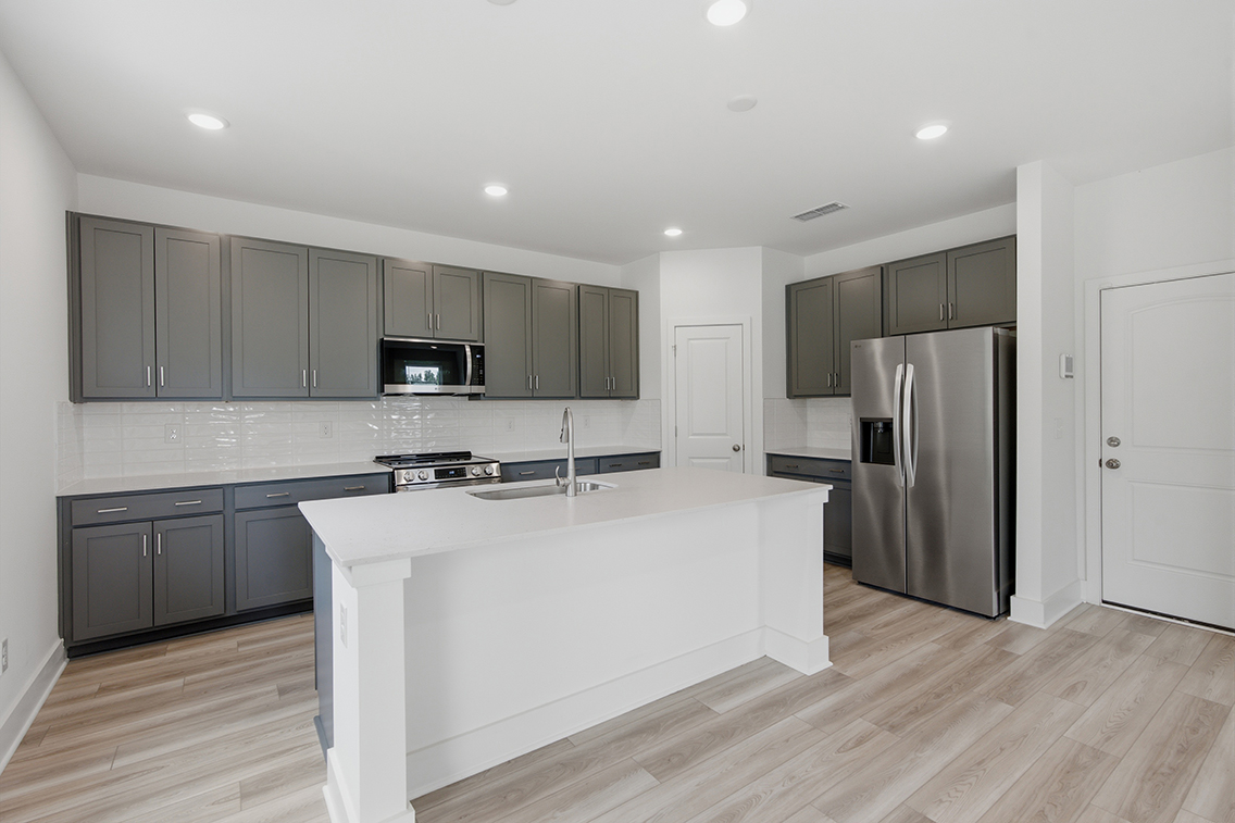 A kitchen with a white counter top.
