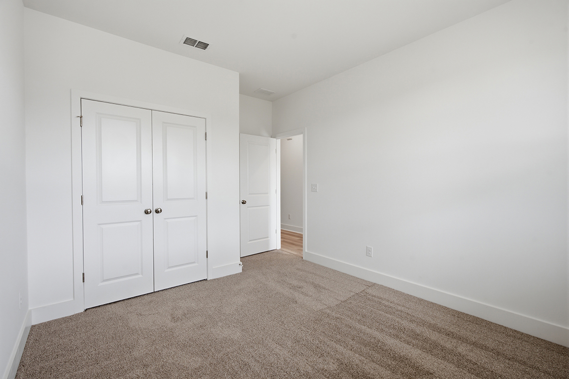 A hallway with white doors.