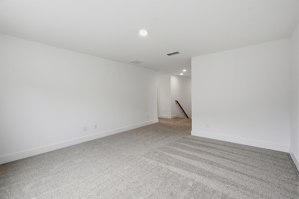 A hallway with white walls.