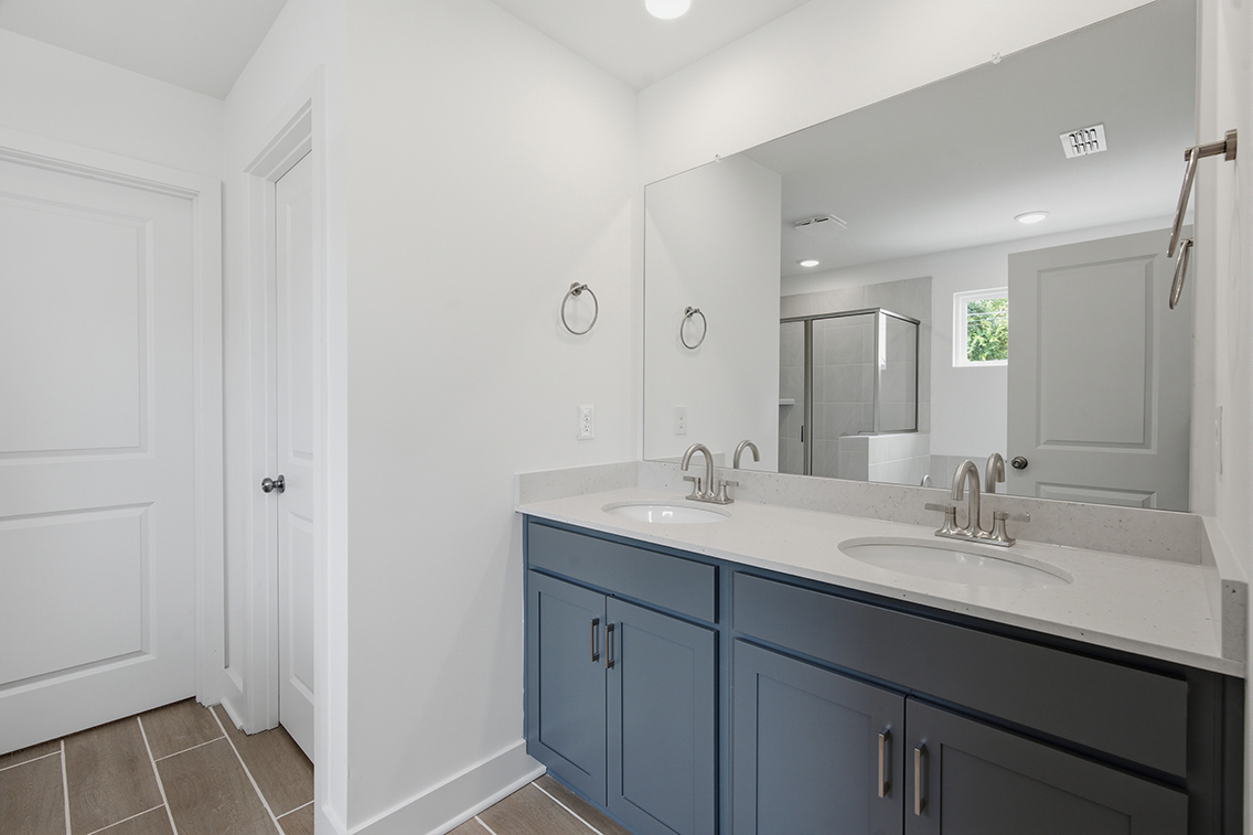 A bathroom with a large mirror.