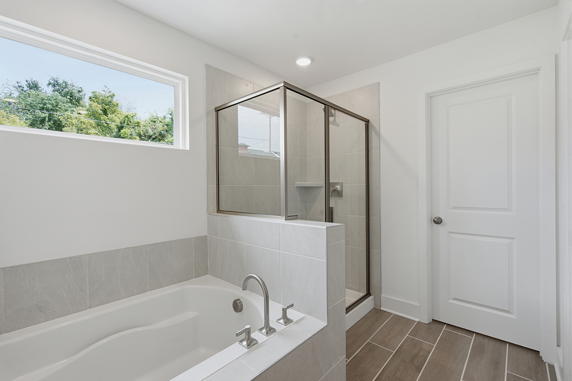 A bathroom with a tub and sink.
