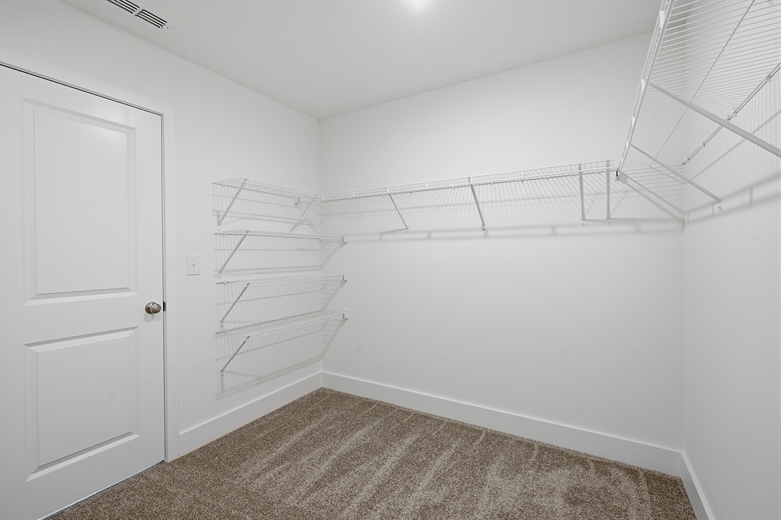 A white room with a staircase.