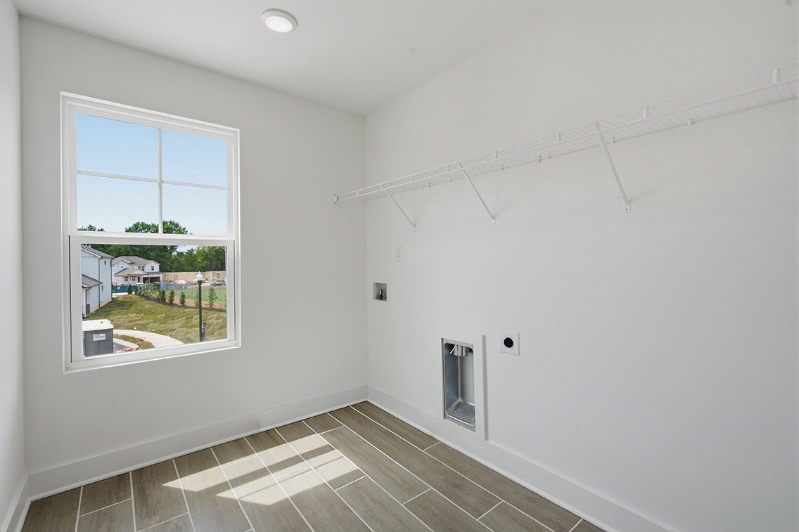 A room with a window and a tile floor.