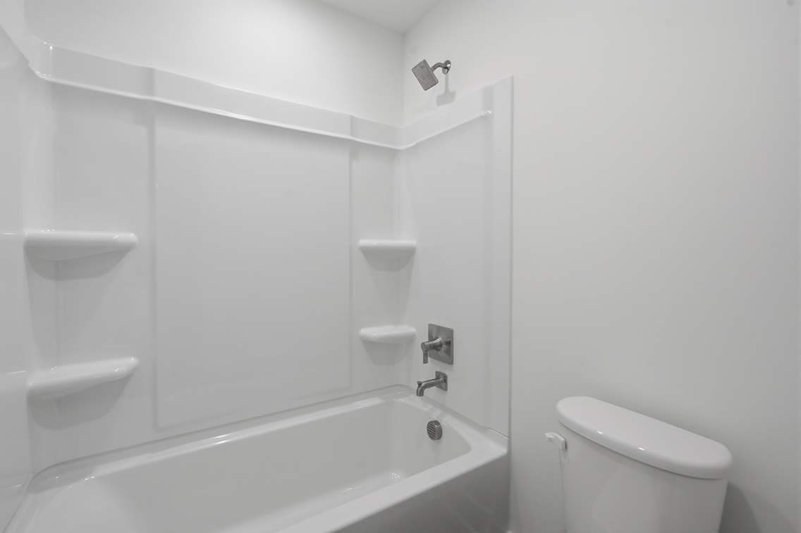 A bathroom with a bathtub toilet and sink.