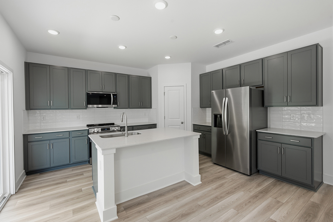 A kitchen with black cabinets.