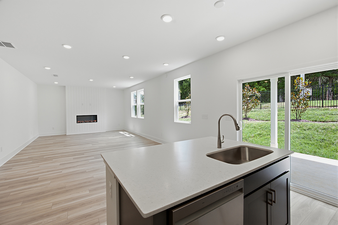A kitchen with a large window.