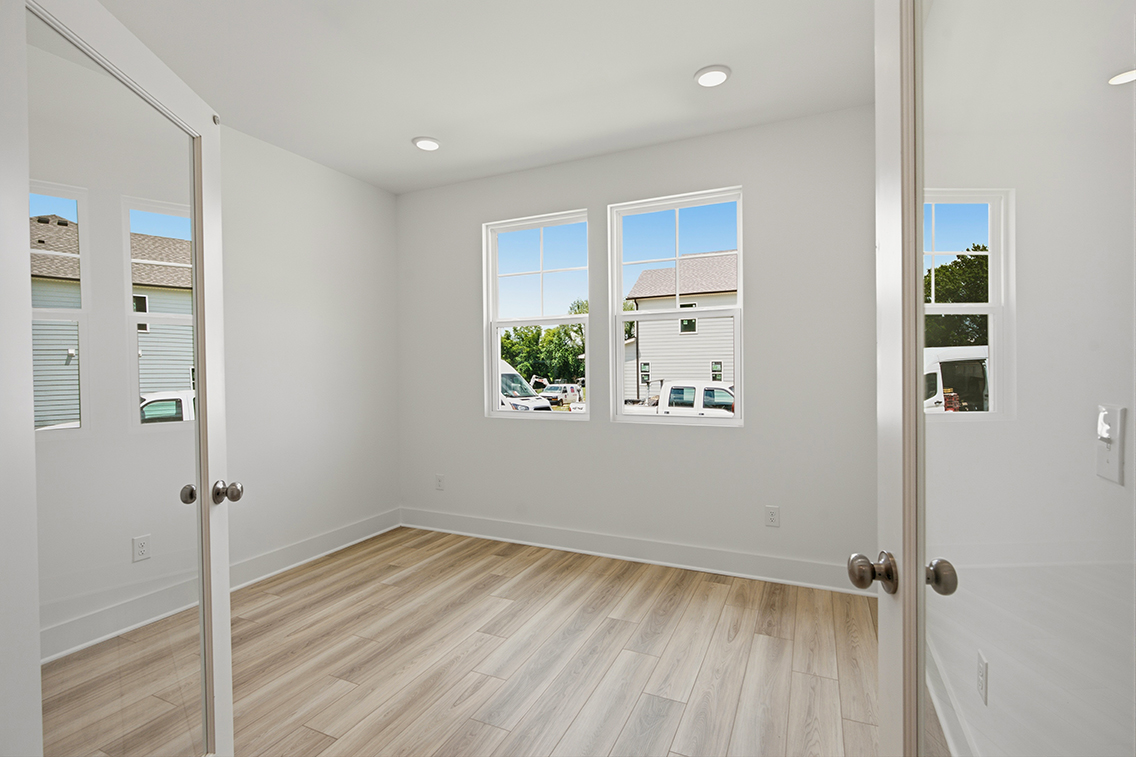 A room with white walls and windows.