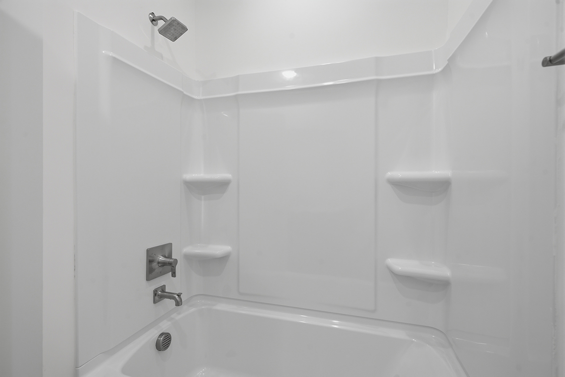 A bathroom with a bathtub and toilet.