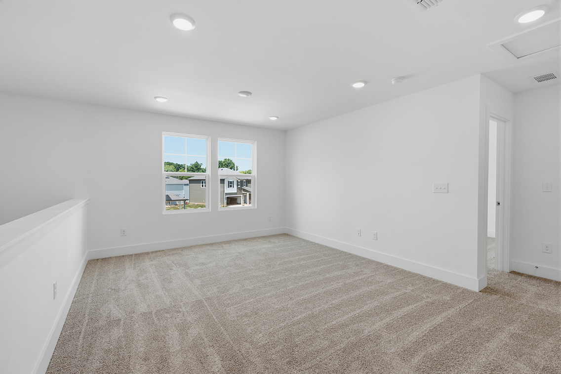 A room with white walls and windows.