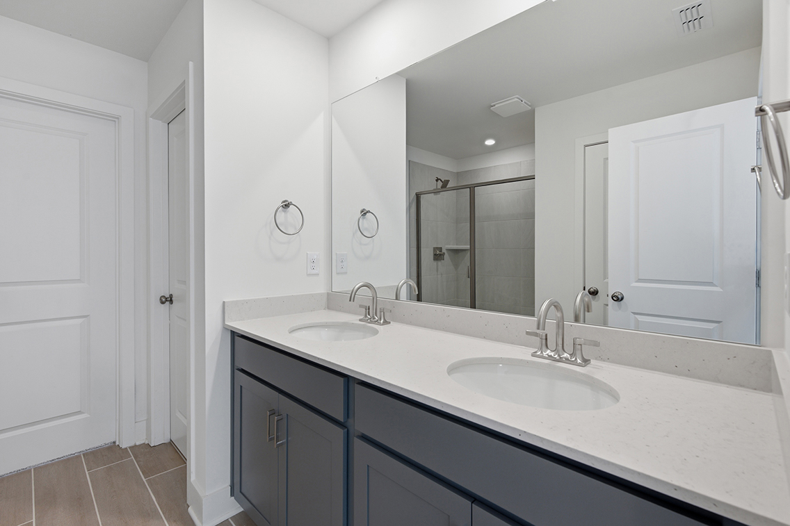 A bathroom with a large mirror.