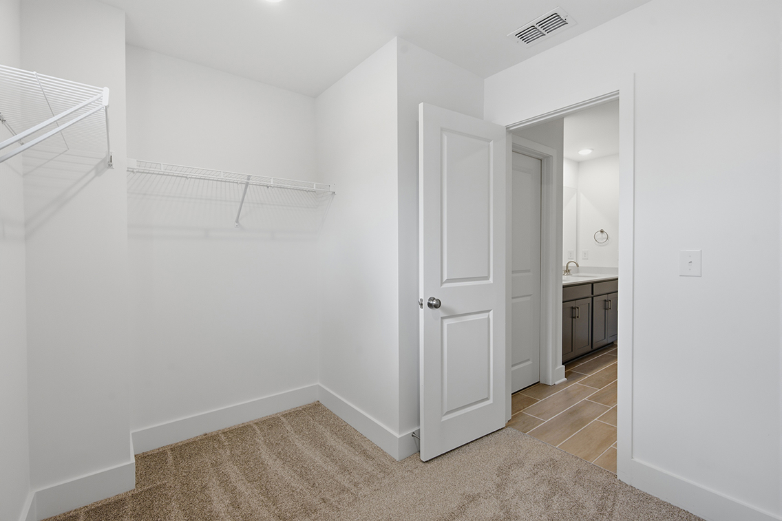 A white room with a door and a white wall.