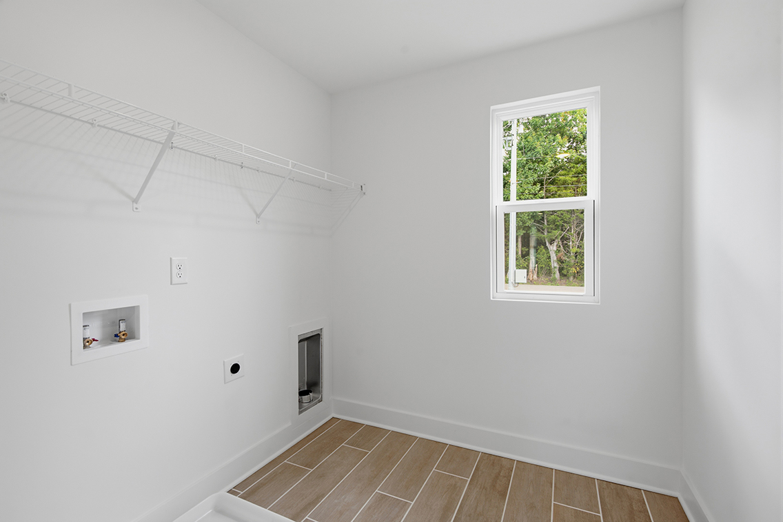 A room with a window and a tile floor.