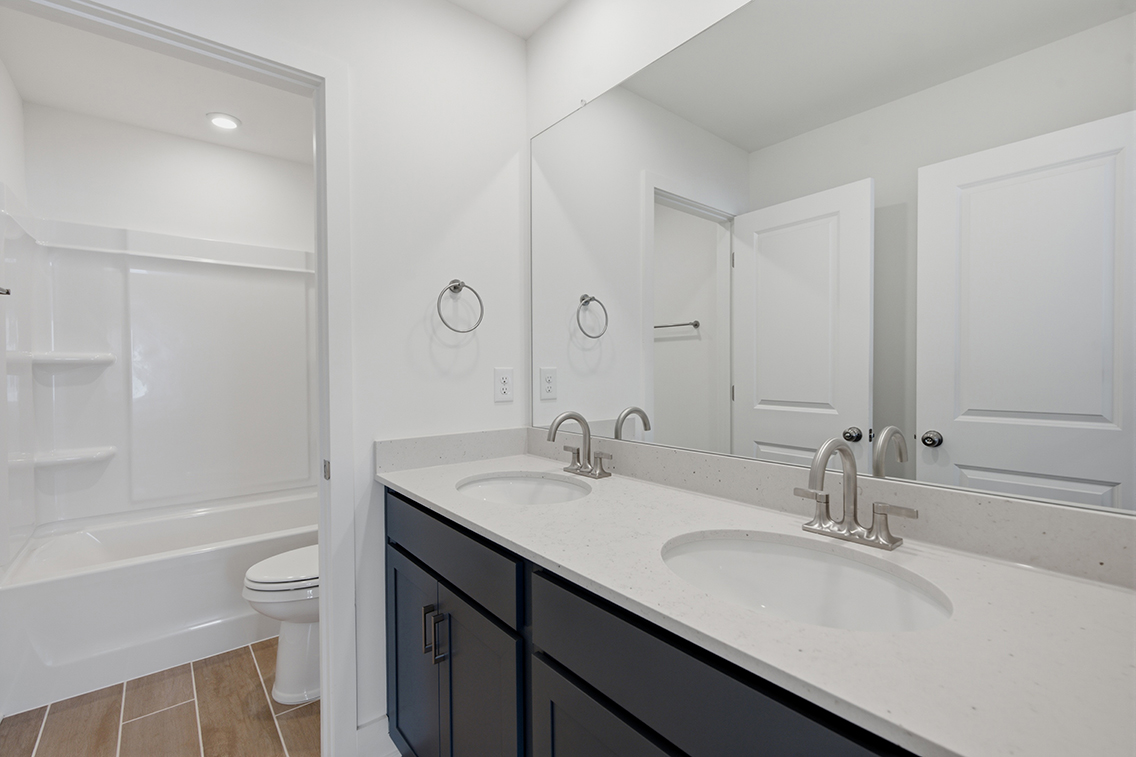 A bathroom with a tub sink and toilet.