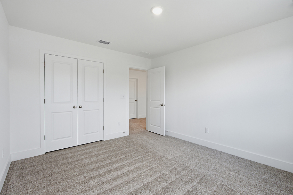 A hallway with white doors.