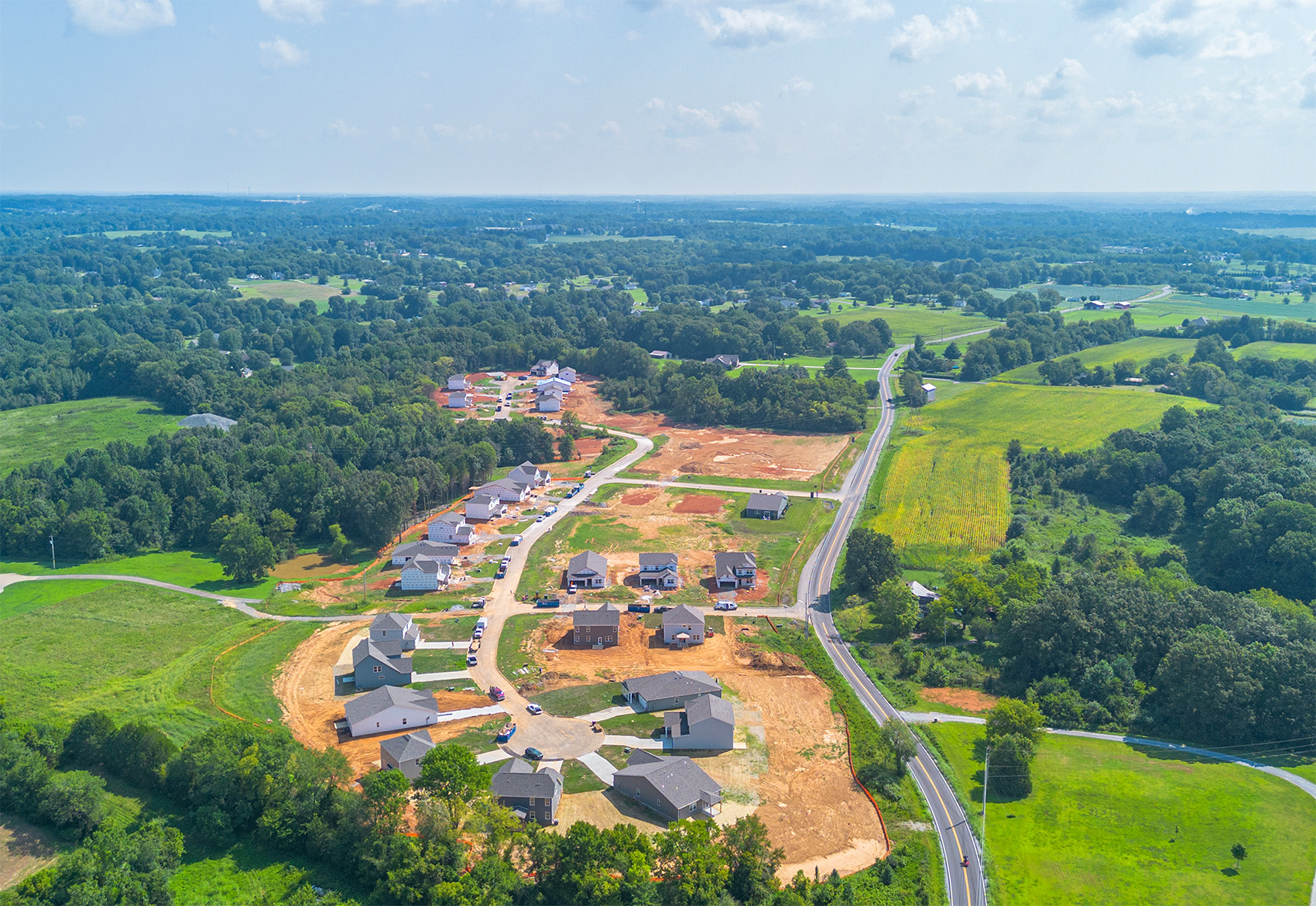 A landscape with houses and trees.