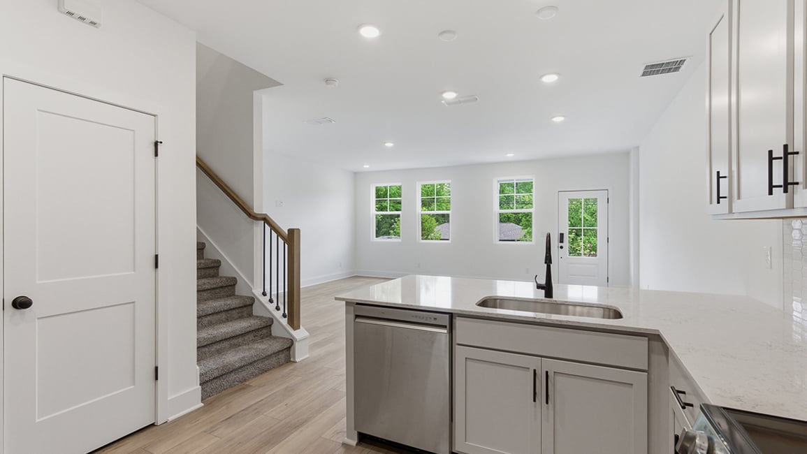 A kitchen with white cabinets.