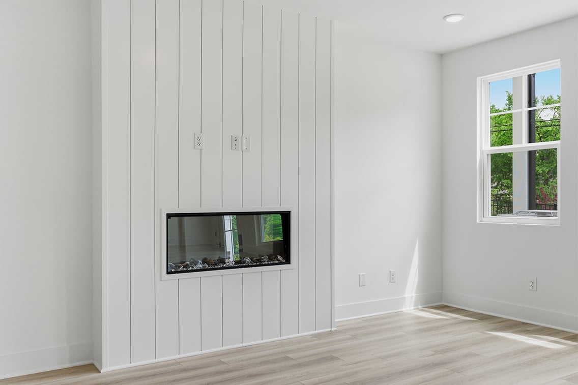 A room with a tv and a window.