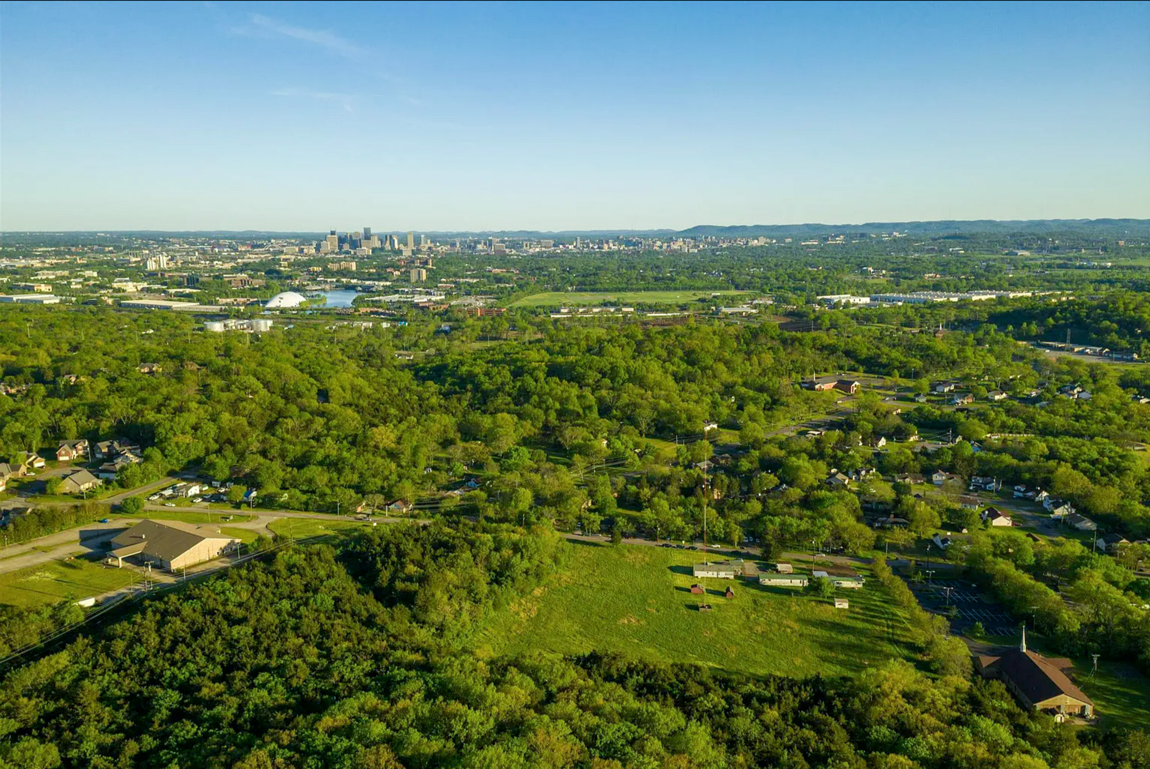 A landscape with trees and buildings.