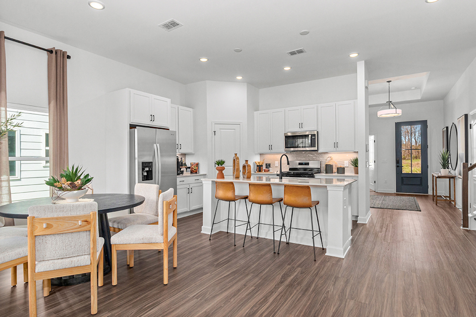 A kitchen with a wood floor.