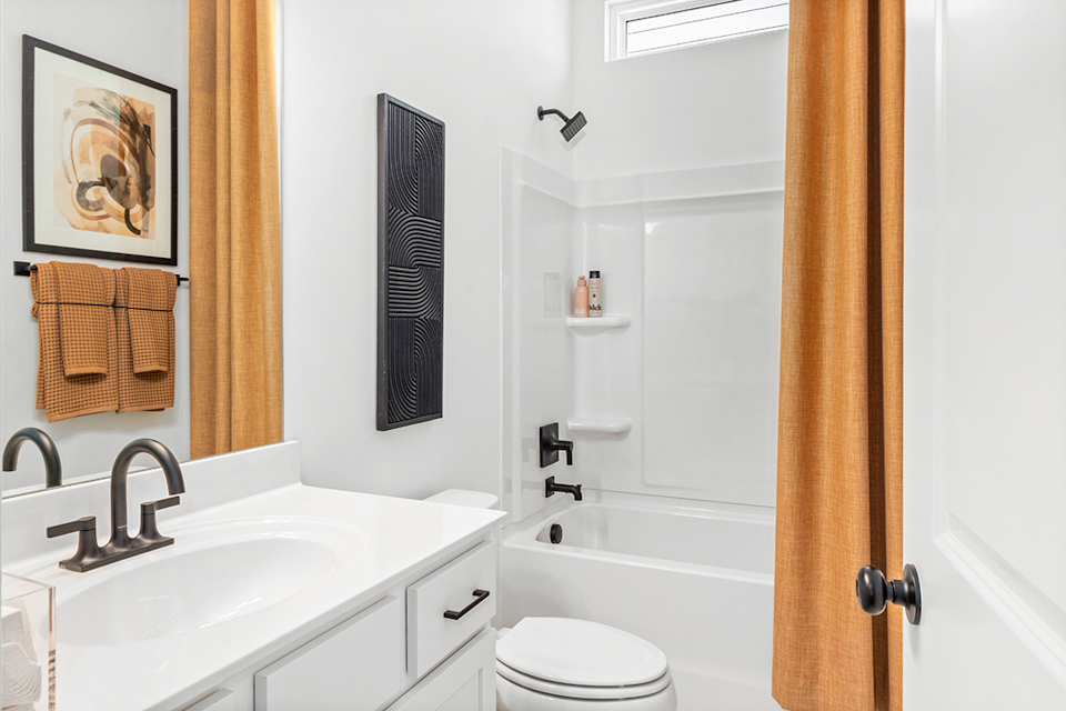 A bathroom with a tub sink and toilet.