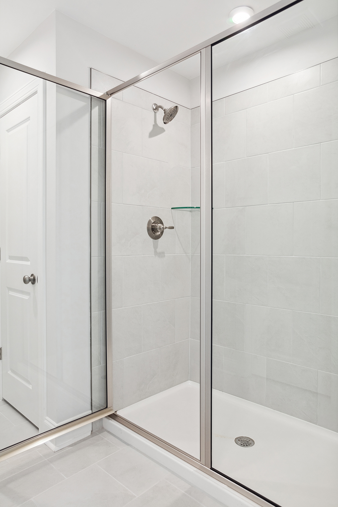 A shower with a glass door.