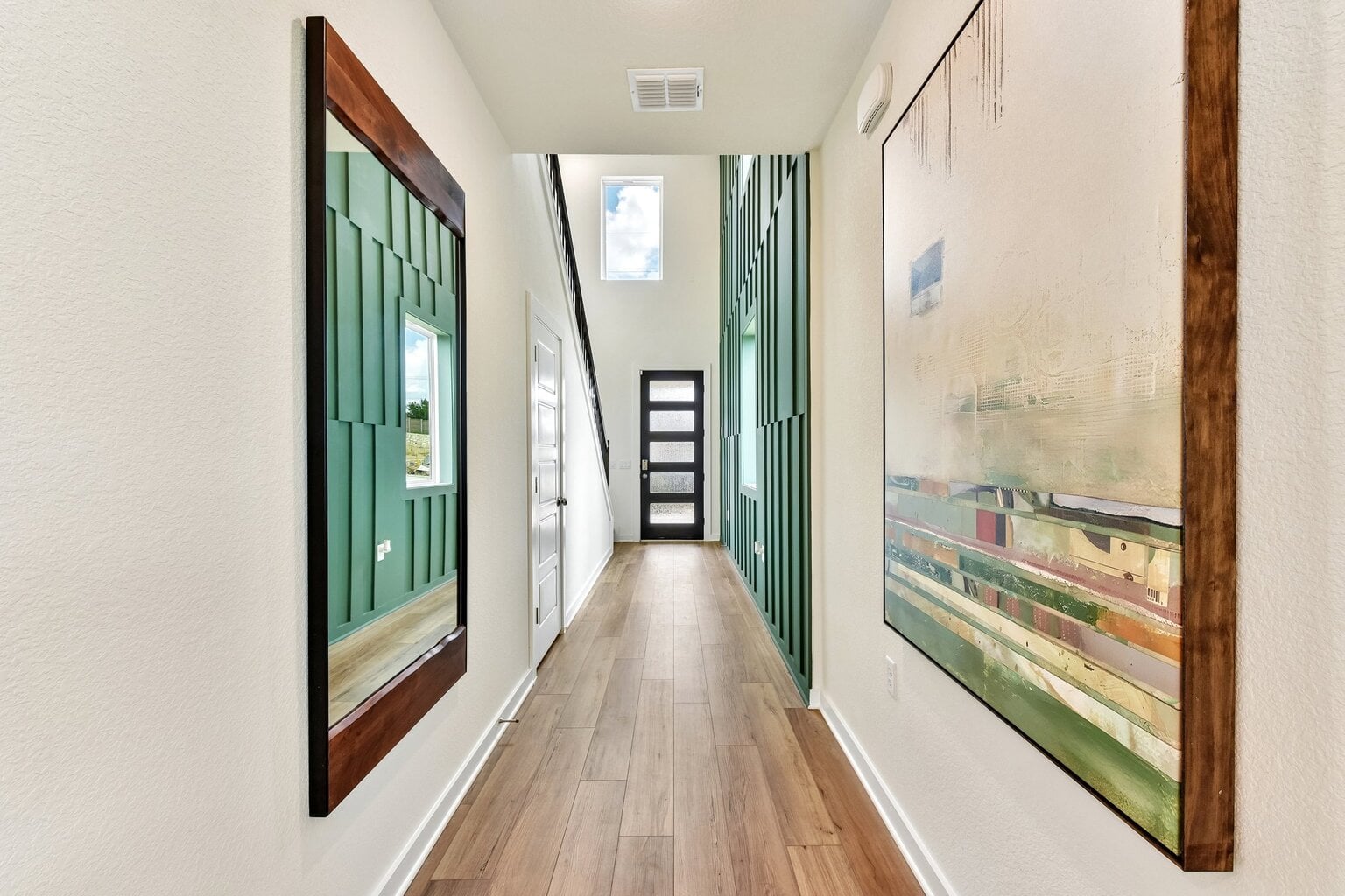 A hallway with green doors.