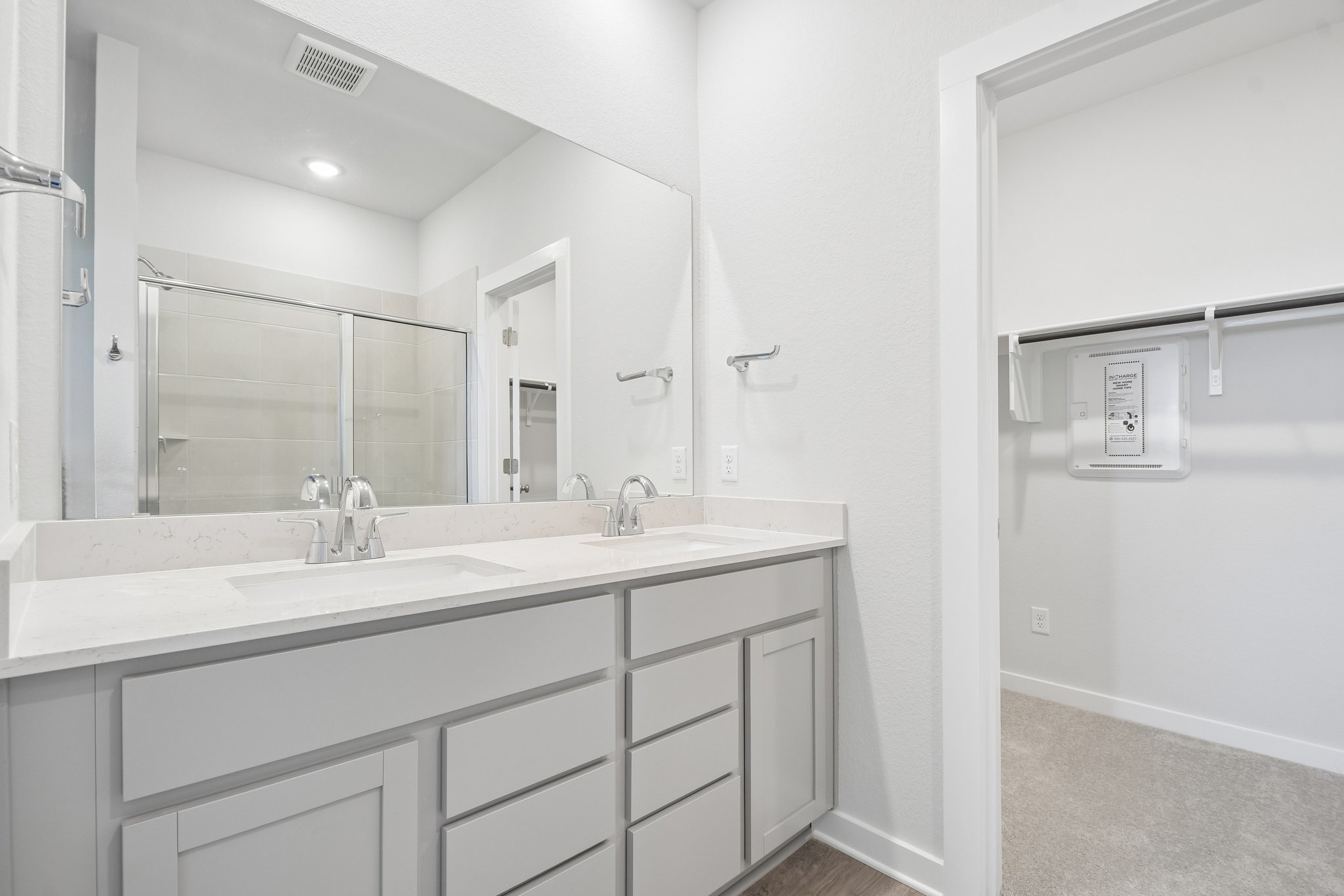 A bathroom with a large mirror.
