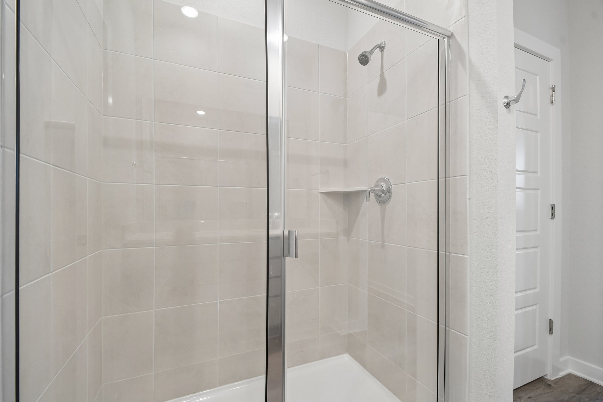 A shower with a glass door.